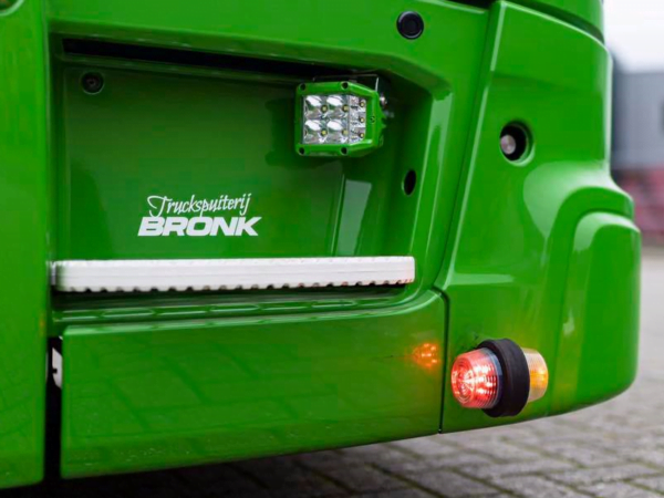 Danish LED side lamp orange - red with transparent glass - mounted in the front bumper of a Scania Next Gen