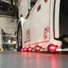 Danish width lamp with Gylle lamp glass RED - mounted with mounting base on sideskirt Scania - EAN: 7392847307866