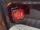 Truck entry with LED work light - work light is equipped with a RED colored position light